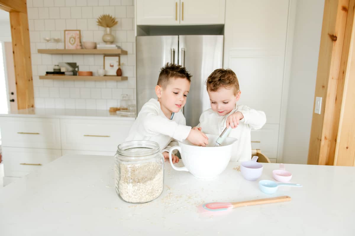 Two little boys making a recipe in the kitchen.