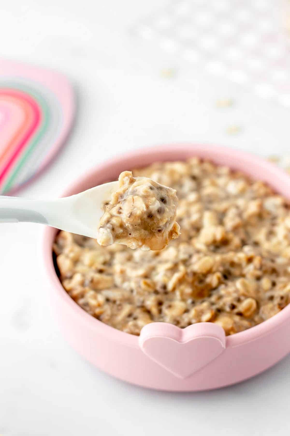 A small spoon holding up some BLW overnight oats.