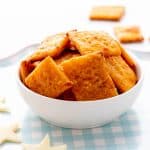 Healthy sweet potato crackers in a small white bowl.