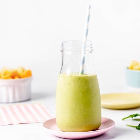 A milk bottle filled with green smoothie without yogurt or banana.