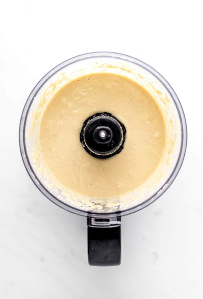 Creamy high protein hummus in a food processor.