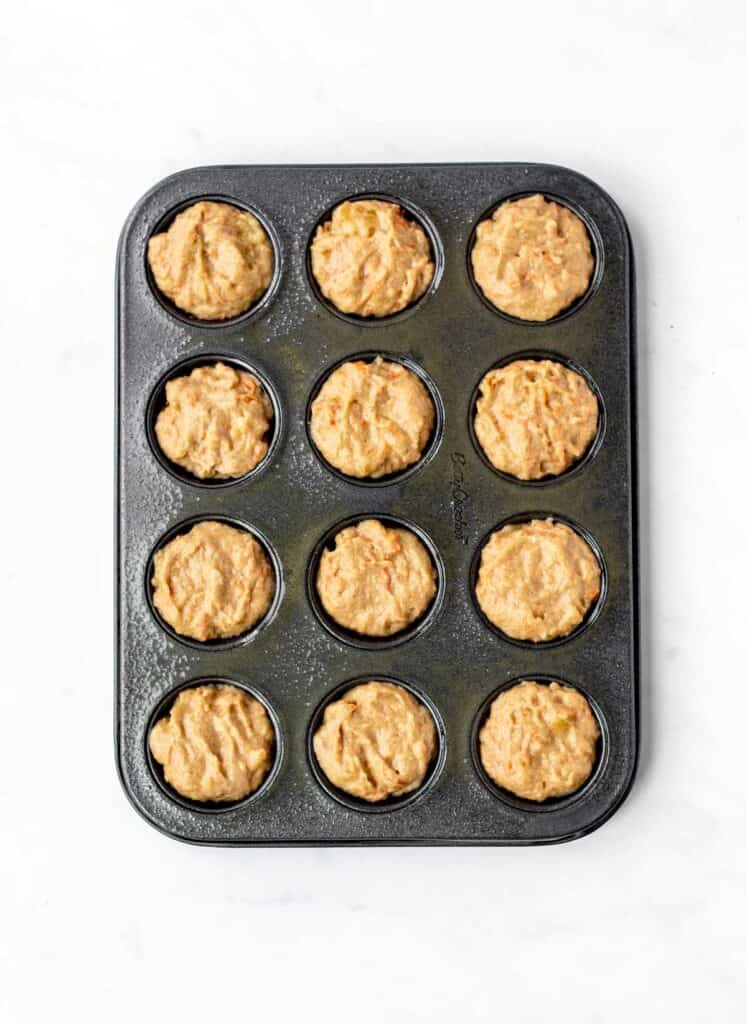 The abc muffin batter divided in a mini muffin pan.