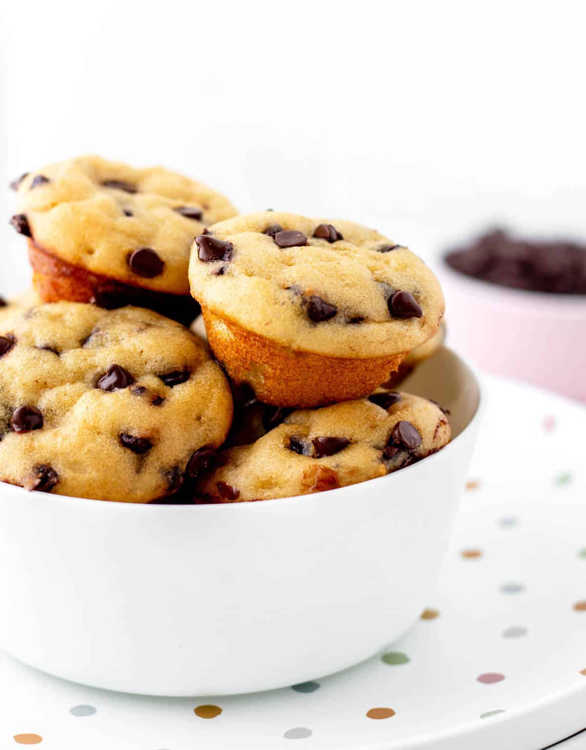 Close up image of mini chocolate chip muffins in a bowl.