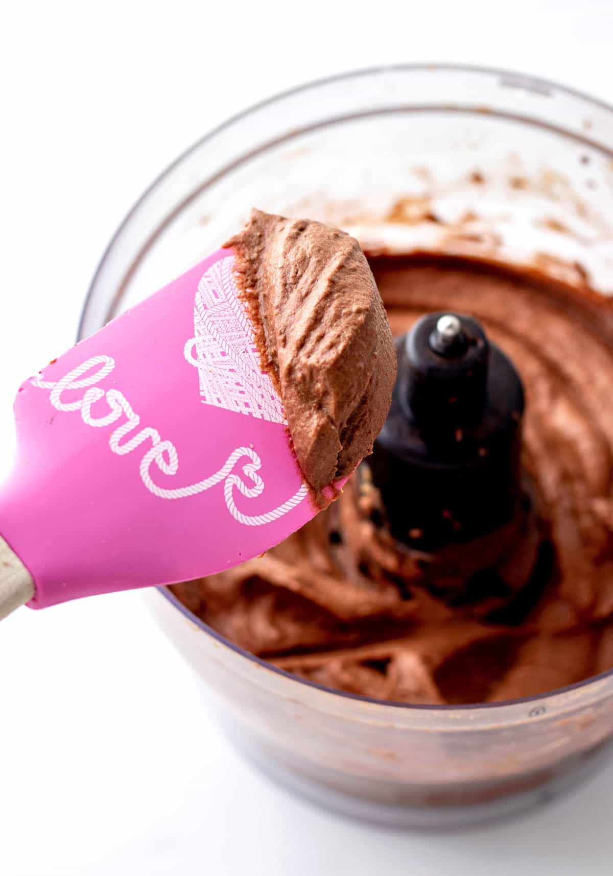 A spatula holding up some of the healthy date frosting.