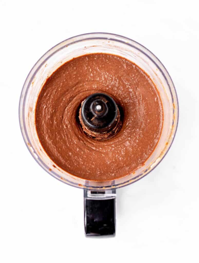 Cocoa powder blended into the date frosting in a food processor.