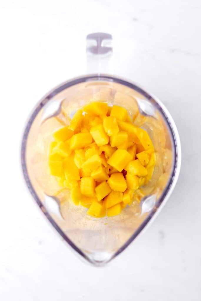 Diced mango in a blender.