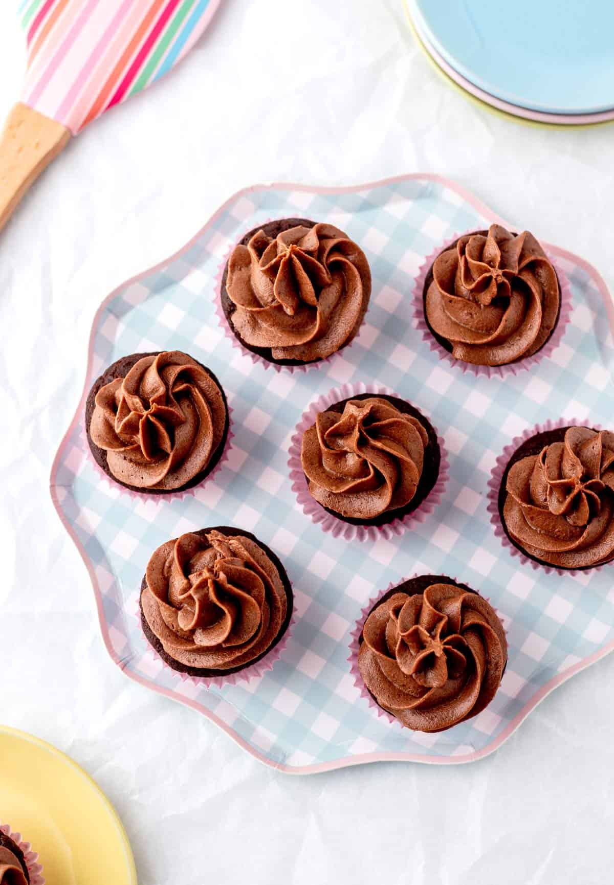 An overhead shot of mini cupcakes topped with healthy chocolate frosting.