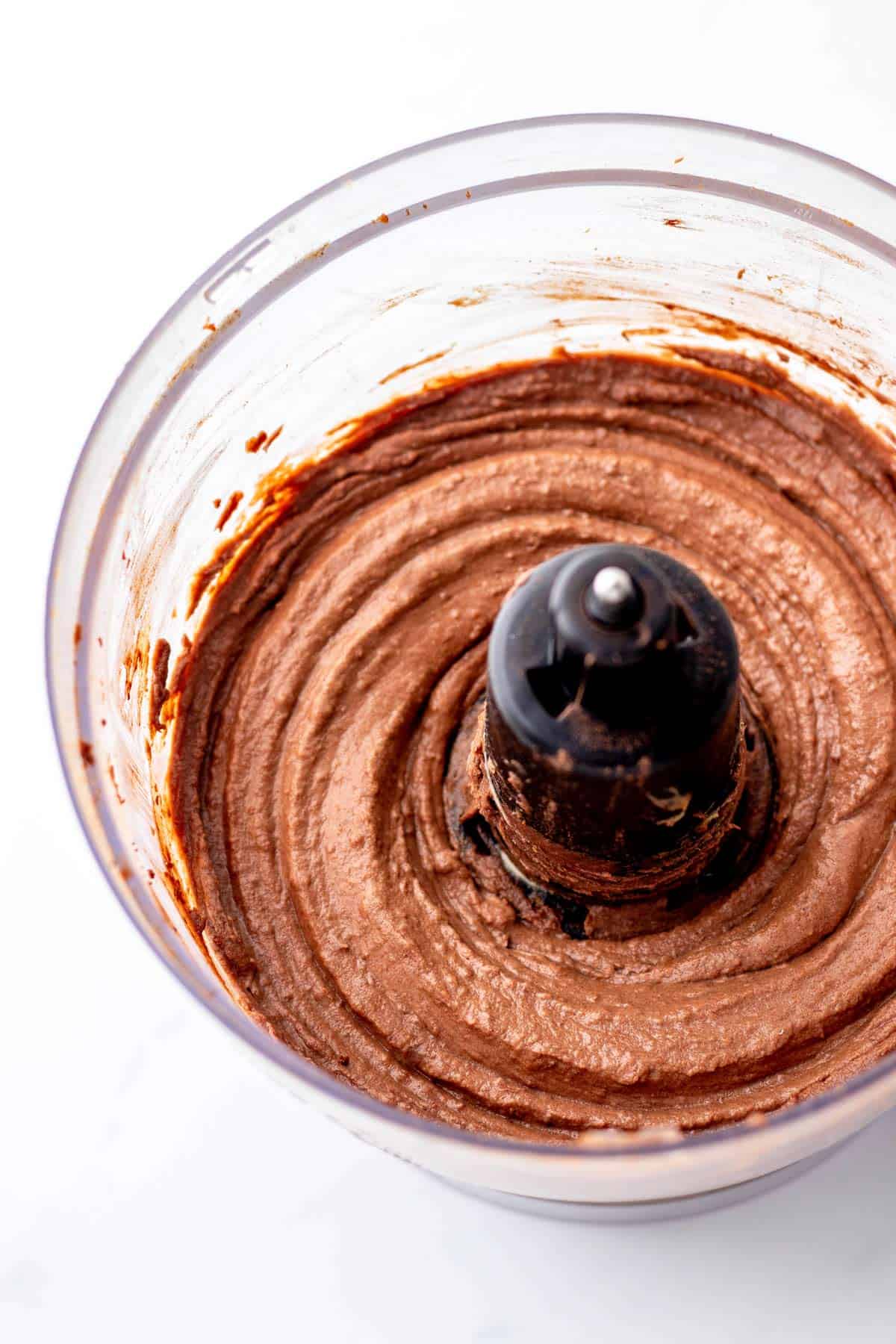 Up close shot of healthy chocolate frosting in a food processor.