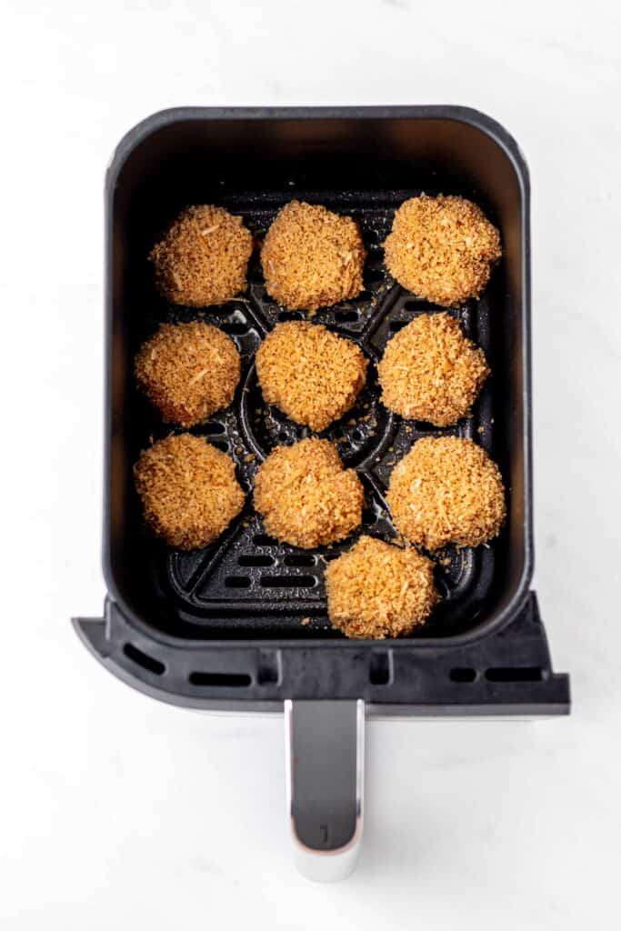The raw chicken nuggets in the air fryer.