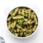 Baby pasta recipe with green sauce in a small teddy bear bowl.