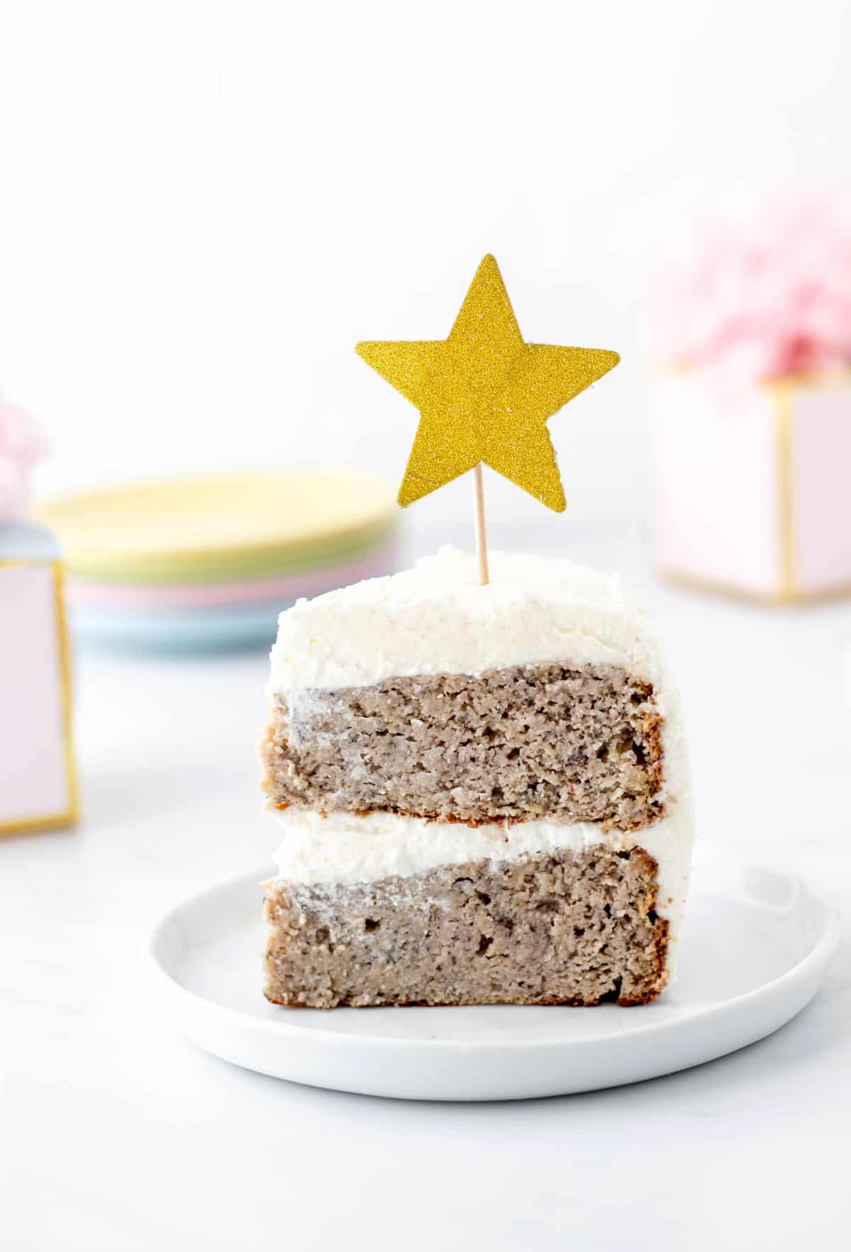 A slice of healthy smash cake on a plate with a star topper.