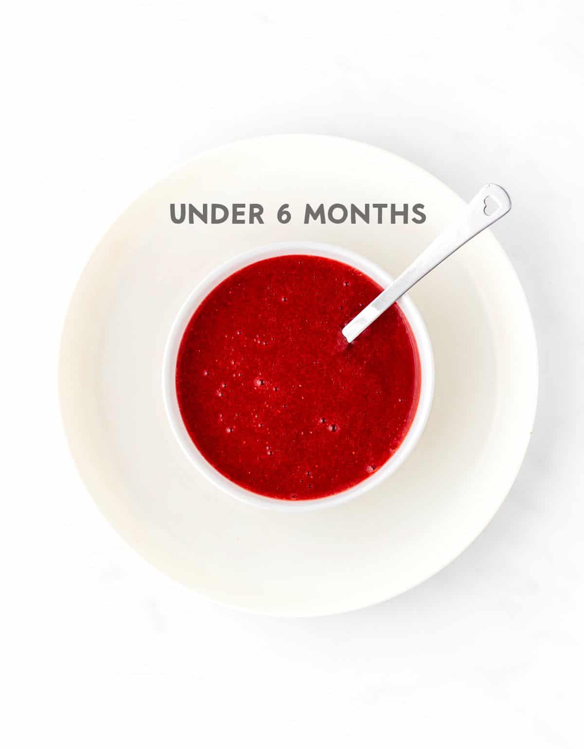 A bowl of strawberry puree for a baby under 6 months old.