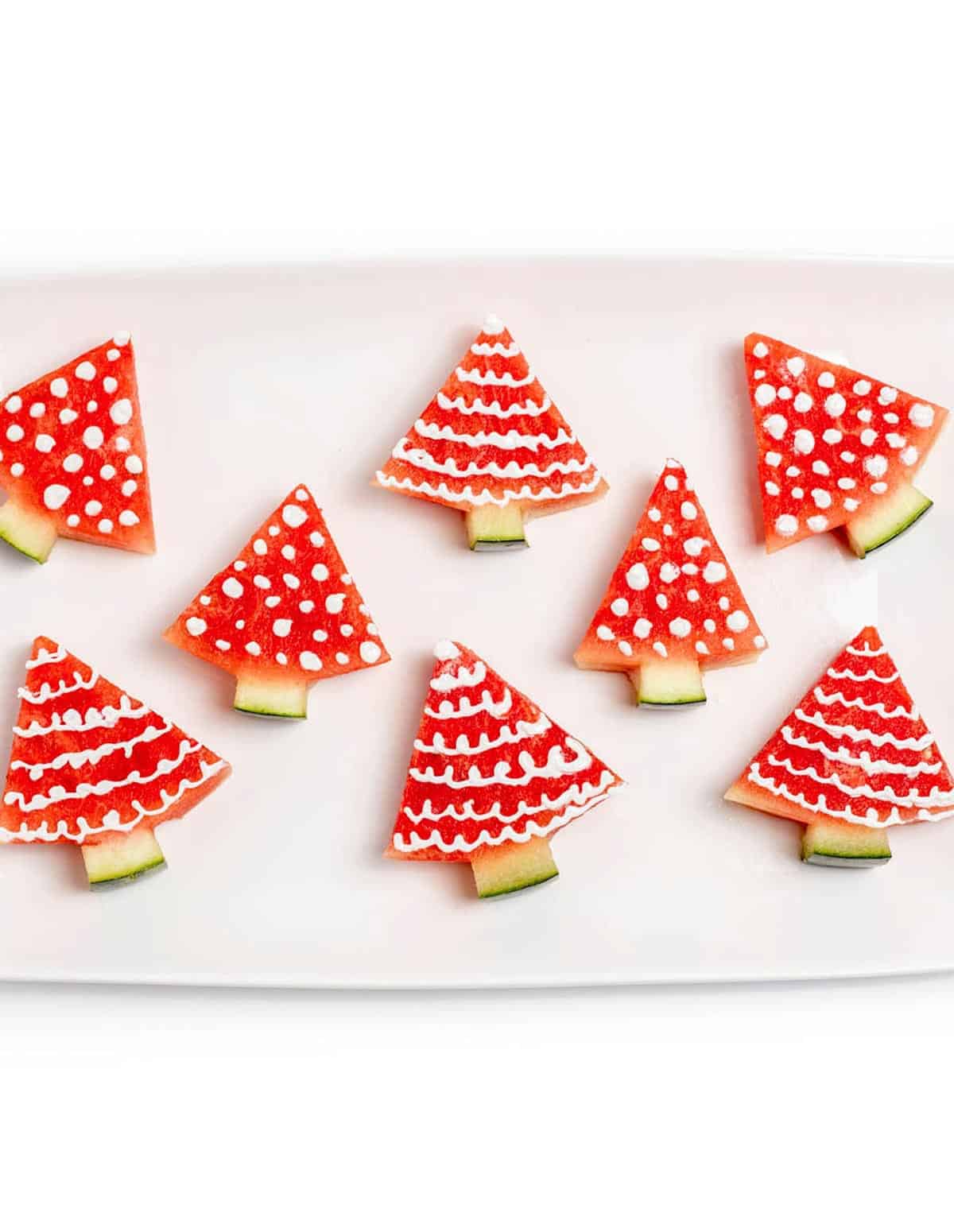 A tray with decorated watermelon Christmas trees.