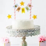 No sugar smash cake for one year old on a cake stand.