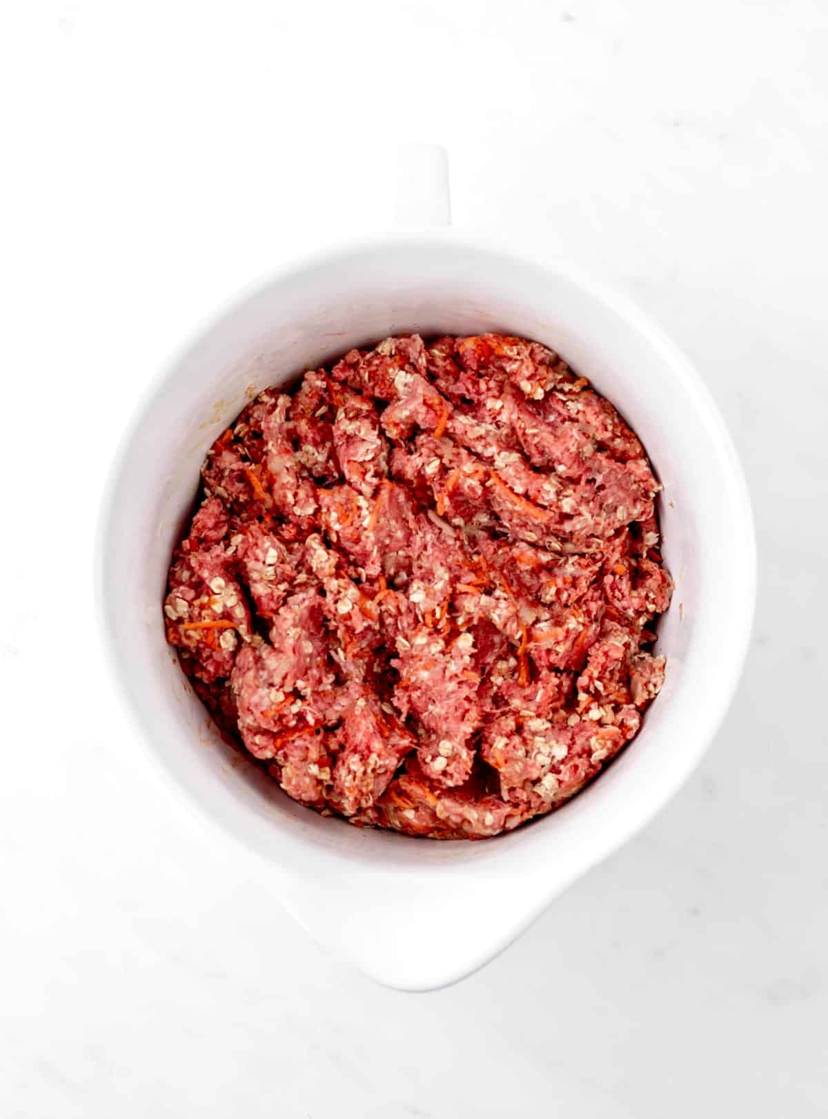 Meatloaf mixture in a bowl combined and ready to make healthy meatloaf recipe with oats.