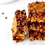 Close up image of a banana pumpkin bar leaning up against a stack of bars.