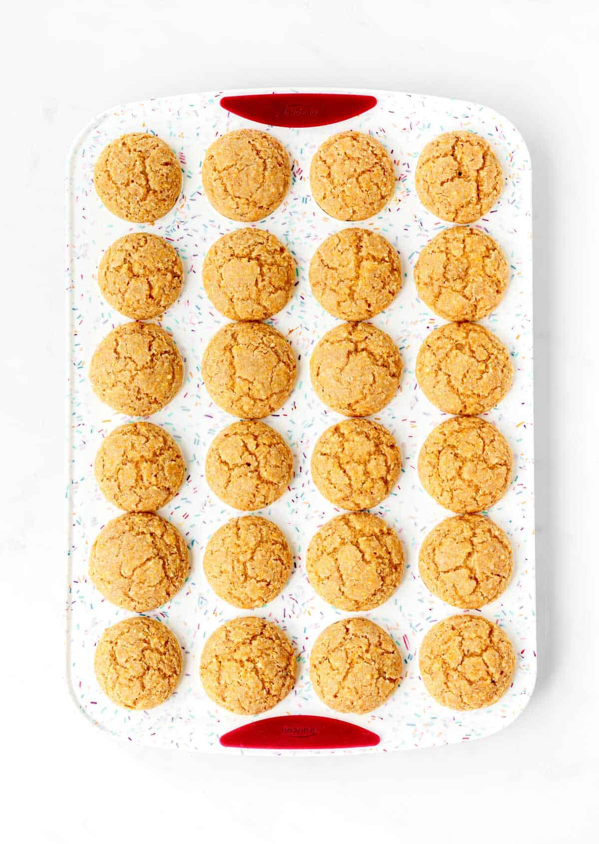 Baked mini cornbread muffins in a silicone muffin tray.