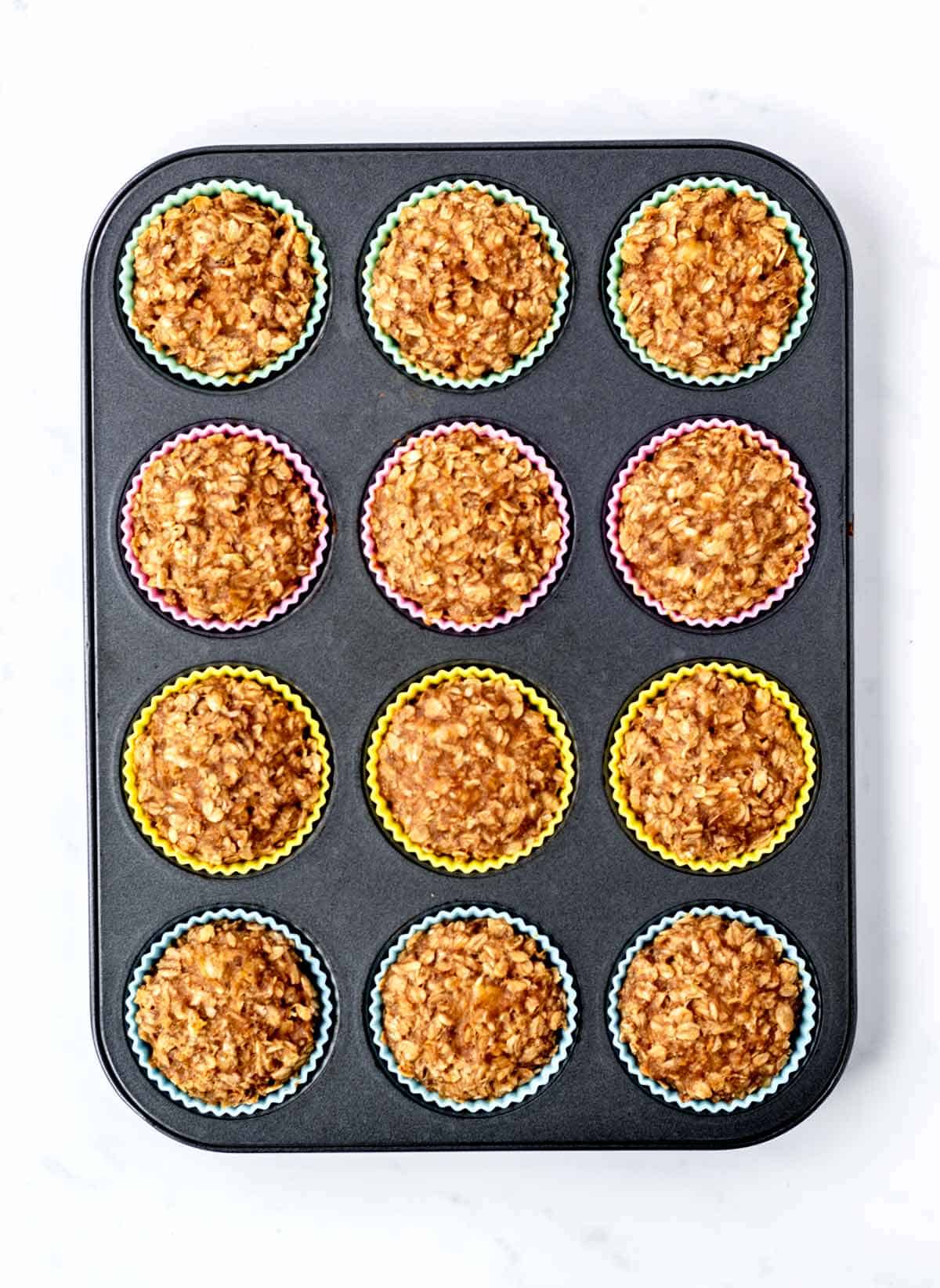 Baked 3-ingredient banana oatmeal muffins in a muffin tin.