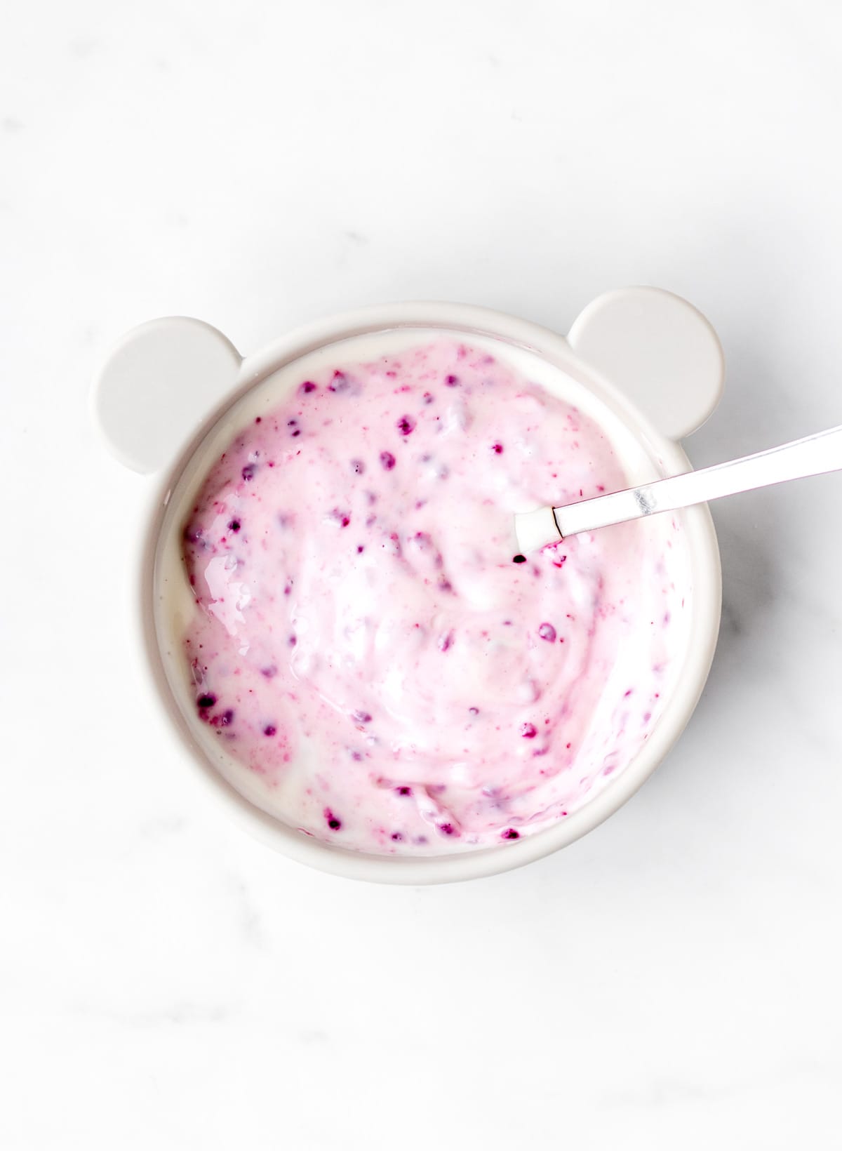 Mixed berry chia jam mixed into yogurt in a teddy bear bowl.