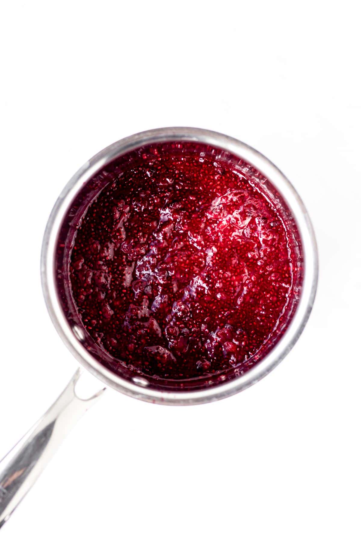 Mixed berry chia jam in a small pot.