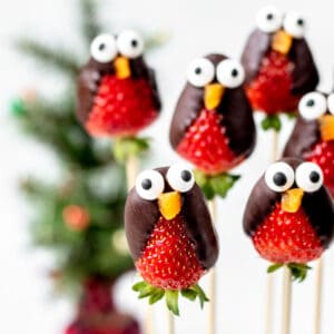 Strawberry penguins on wooden skewers.
