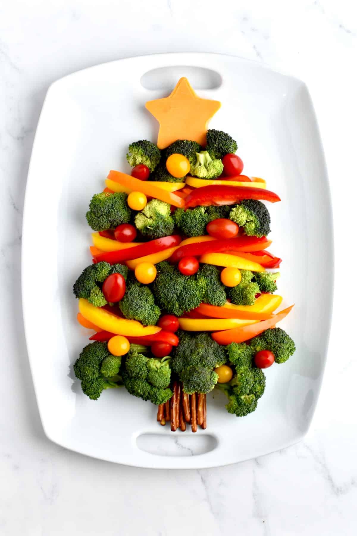 A broccoli Christmas tree veggie tray on a white platter.