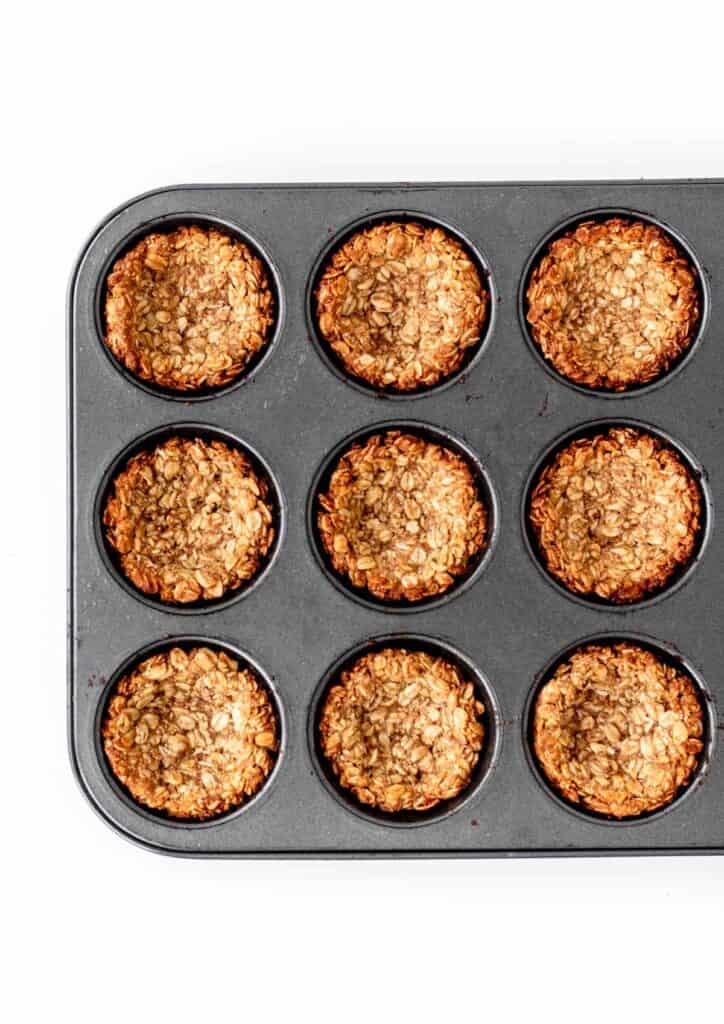 A birds-eye view of the granola cups in the muffin pan after baking.