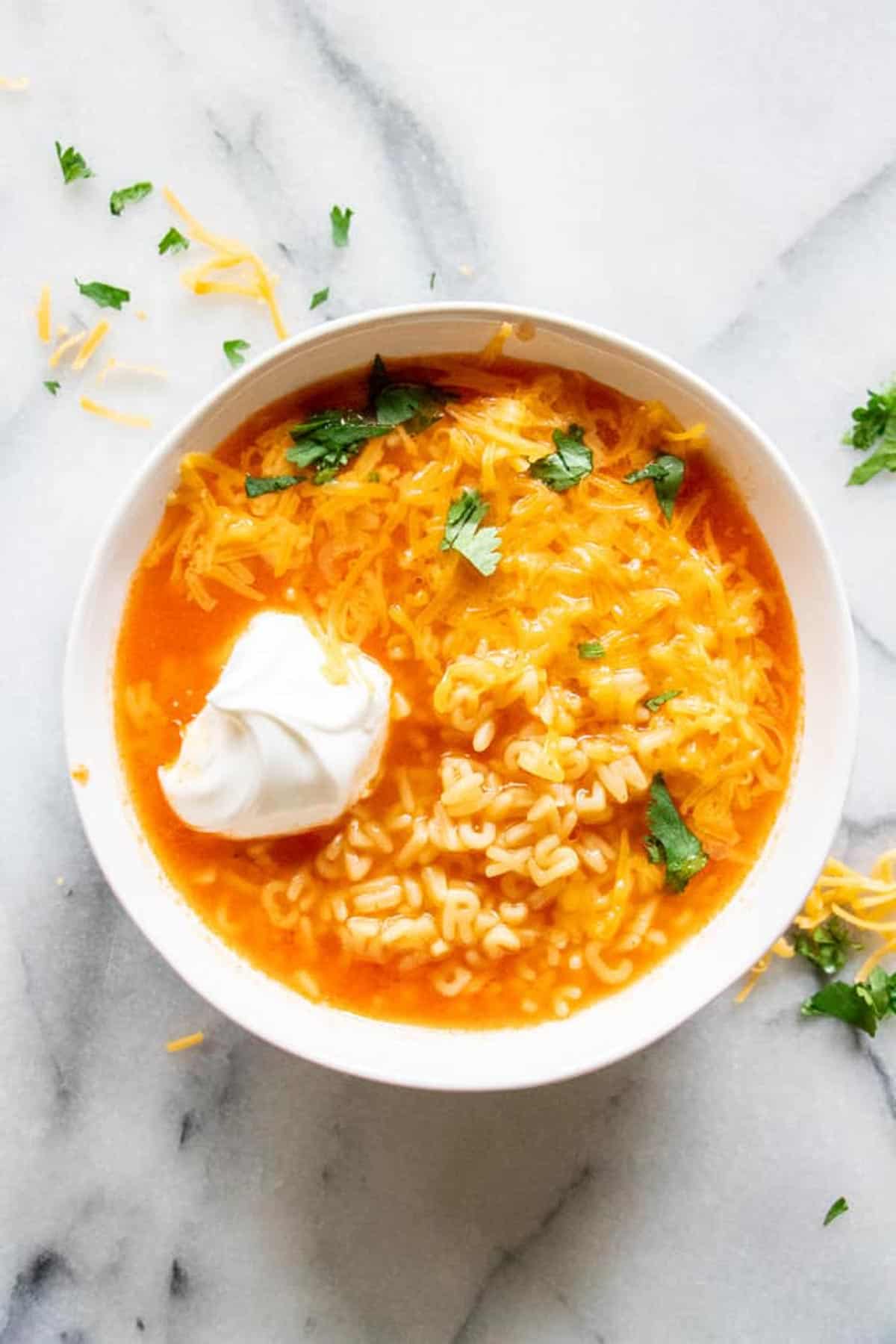 Mexican ABC soup in a bowl topped with sour cream.