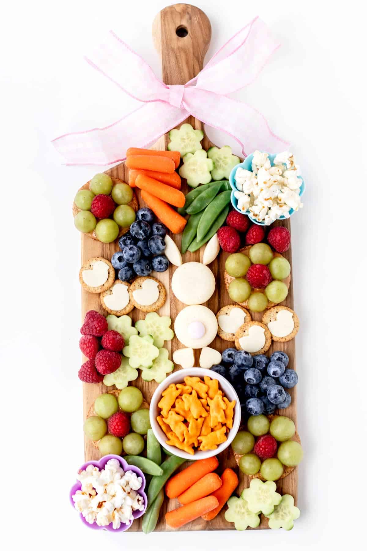 An Easter bunny snack board, with an Easter bunny made of baby bel cheese and surrounded by various snacks.